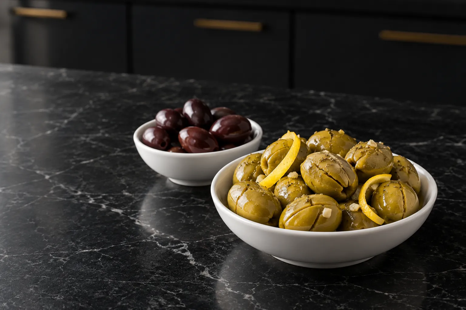 Cracked green olives with oregano and lemon beside black olives