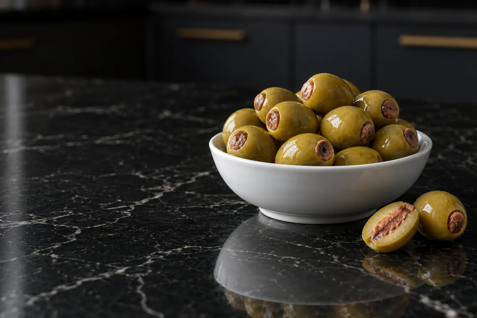 Green olives stuffed with anchovy in a white bowl